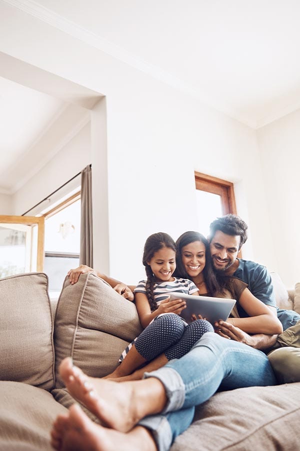 family sitting on a couch searching