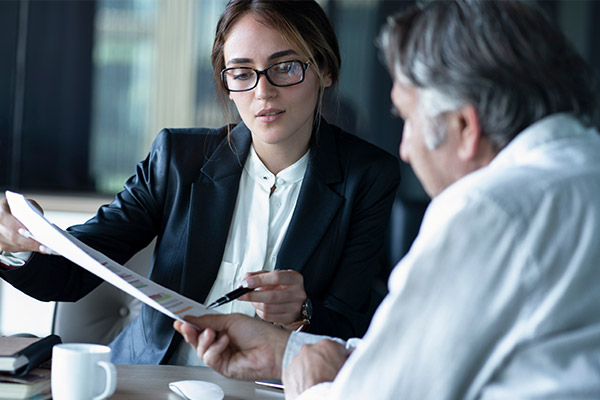 man sitting with female attorney trying to sell an inherited property