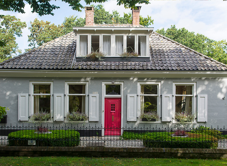 Gray cottage-style home with pink front door and white shutters in Olneyville, Providence RI — sell your house fast for cash with We Pay More Properties